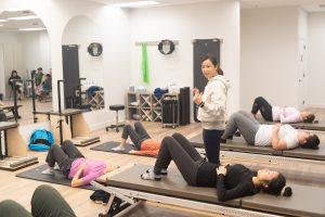 Small group Pilates class in East Vancouver focused on posture and core strength.